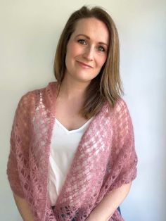 a woman wearing a pink knitted shawl