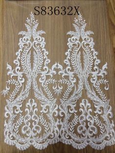 two white lace trims on a wooden surface with the words s3882x