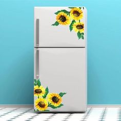 a refrigerator with sunflowers painted on the front and bottom doors, in a blue room