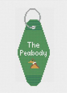 a cross stitch keychain with the words,'the freakboy'on it