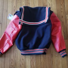 Navy With Red Sleeves. Size Xs With Shortened Sleeves. 16 1/2 Sleeve Length From Arm Pit To End Of Sleeve. 21 1/2 Long From Neck Down 24 1/2 From Back Of Neck Down Paid $225 Still Has Tags Red Fitted Varsity Outerwear, Fitted Varsity Jacket With Pockets, Fitted Navy Outerwear For Streetwear, Fitted Varsity Jacket With Padded Collar, Fitted Red Varsity Jacket, Red Fitted Varsity Jacket, Fitted Long Sleeve Varsity Jacket With Padded Collar, Fitted Navy Retro Outerwear, Navy Fitted Retro Outerwear