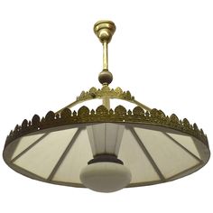 a light fixture hanging from the ceiling with an ornate design on it's side