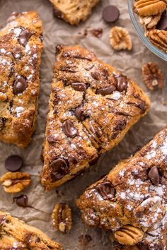 several pieces of chocolate chip pecan bread on parchment paper with more pecans around them