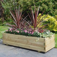 a wooden planter filled with lots of flowers