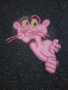 a drawing of a pink cat on the ground