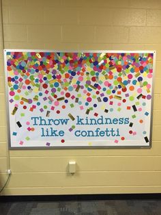 a bulletin board with confetti on it and the words throw kindness like confetti