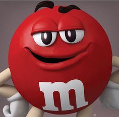 a close up of a red m & m's ball with eyes and hands