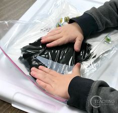 a person holding a plastic bag on top of a table