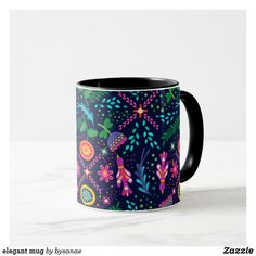 a black and blue coffee mug with colorful designs on it