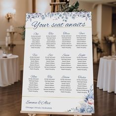 a seating chart for a wedding with blue flowers on it and greenery in the background