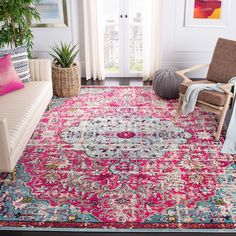 a living room filled with furniture and a pink rug