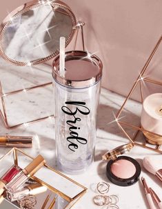 the contents of a beauty product on a marble table with gold and pink accessories around it