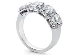 a three stone diamond ring on a white background