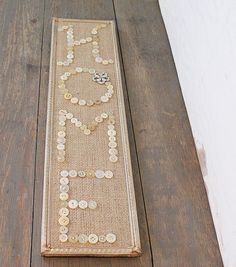 a wooden floor with a long beaded piece on it