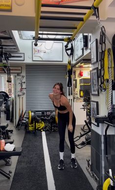 a woman standing in the middle of a gym