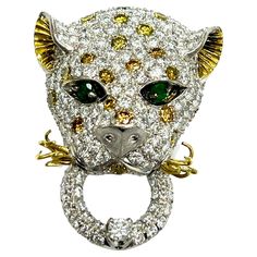 Leopard Diamond Emerald White & Yellow Gold Brooch Two hundred twenty-six round brilliant-cut diamonds of approximately 15.82 carats total, with SI1 clarity, and twenty irradiated yellow and two hundred six H color; two natural emeralds for eyes of approximately 0.20 carat; set on 14 karat white and yellow gold Size: width 3 cm, length 4.1 cm Total weight: 22.6 grams Alexis Bittar Jewelry, Gold Brooch, Gold Brooches, Alexis Bittar, Natural Emerald, Round Brilliant Cut Diamond, Brilliant Cut Diamond, Yellow White, Diamond Cuts