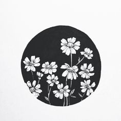 a black and white drawing of flowers in a circle