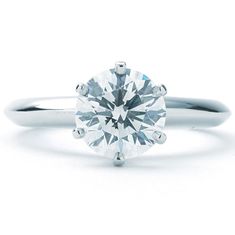 a white gold ring with a round brilliant cut diamond