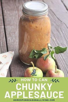 a jar filled with chunky apple sauce sitting on top of a wooden table next to apples