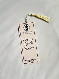 a bookmark with a tassel hanging from it's side on a bed