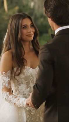 the bride and groom are smiling at each other