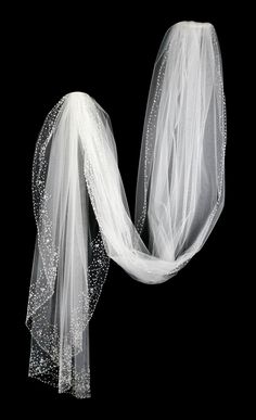 the veil is white and has beads on it