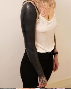 a woman with black paint on her arm