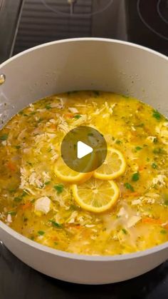 a pot full of soup with lemons and parsley