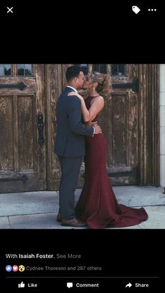 a man and woman standing next to each other in front of a wooden door with the caption,