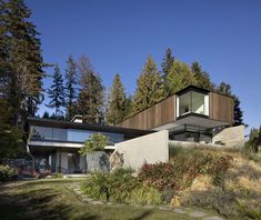 the house is surrounded by trees and grass