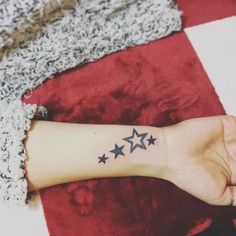 a woman's arm with five stars on it