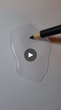 someone is drawing something on the paper with a pencil