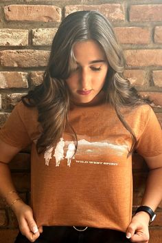 Saddle up and show off your wild west spirit with this tee! Embrace your inner cowgirl/cowboy and let this shirt take you on a wild ride. Yeehaw! Cowgirl Cowboy, Social Development, Western Boho, Wild West, Men's Collection, Haiti, Women Empowerment, Saddle, Apparel Accessories