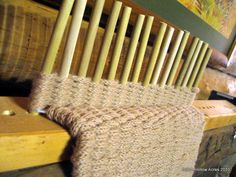 a wooden chair sitting on top of a floor next to a pile of wood planks