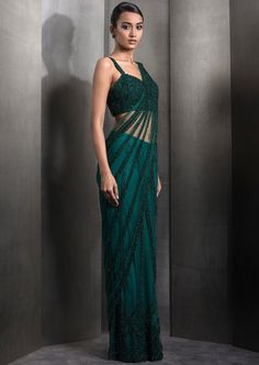 Draped pre-stitched tulle sari embellished with tonal embroidery with matching embroidered blouse. Embroidery Details: Fully Embroidered With Metallic Sequins And Hematite's Paired With Fully Embellished Blouse. Evening Saree With Intricate Embroidery, Semi-stitched Embellished Saree For Evening, Green Blouse Piece With Resham Embroidery For Evening, Evening Saree With Intricate Embroidery, Semi-stitched, Embroidered Floor-length Blouse Piece For Evening, Embellished Green Saree For Evening, Evening Embroidered Semi-stitched Saree, Evening Pre-draped Saree With Intricate Embroidery, Green Embellished Evening Blouse Piece