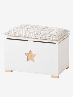 a white toy chest with a wooden star decoration