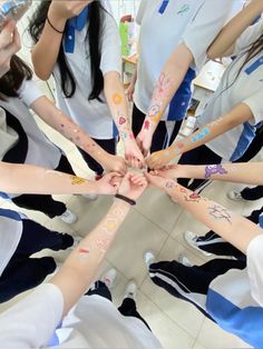 a group of people with their hands together