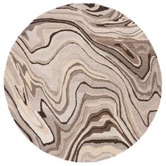 a round rug with an abstract design in beige, brown and white colors on it