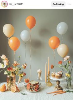 an assortment of desserts and balloons on a table