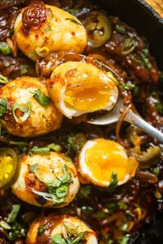 cooked eggs and onions in a skillet with a spoon on the side, ready to be eaten