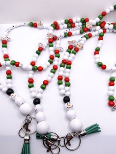 a white and green beaded necklace with keychains