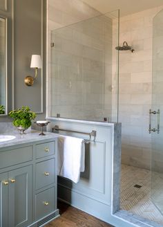 a bathroom with two sinks, a shower and a large mirror on the wall above it