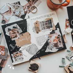 an open scrapbook surrounded by crafting supplies and other items on a table top