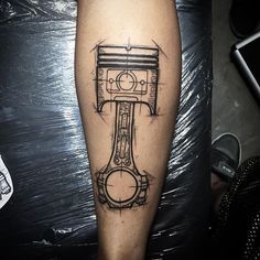 a man's leg with a tattoo on it that has an image of a machine