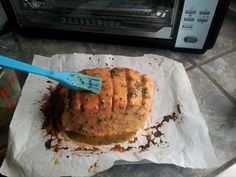 a toaster oven sitting on top of a counter next to a piece of bread