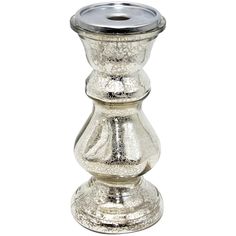 a silver candle holder sitting on top of a table