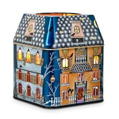 a blue and white house shaped vase with lights