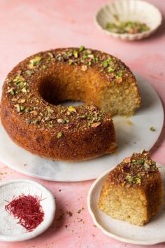 a bundt cake sitting on top of a white plate next to two small plates