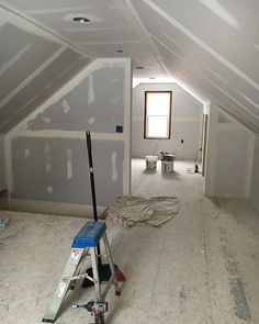 an empty room with some tools on the floor and paint being applied to the walls