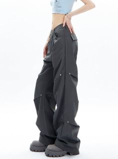 Elevate your wardrobe with our luxurious Charcoal Gray Cargo-Style Wide-Leg Pants. Crafted with a cargo-style design and a wide-leg fit, these pants offer both style and comfort. Perfect for any occasion, these pants are versatile and will add a touch of sophistication to your look. Material Info: Polyester 100% Model info: Height: 165 cm Weight: 45 kg Size worn: M Futuristic Clothing, Style Wide Leg Pants, Grunge Accessories, Work Suits, Casual Wide Leg Pants, Sweatshirt Set, Edgy Look, Black Khakis, Cargo Trousers